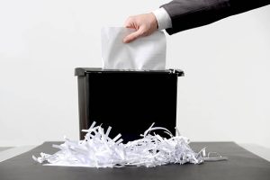 hand of business man paper shredding